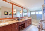 Beautiful bathroom features twin vanities, large closet, toilet and large walk-in shower